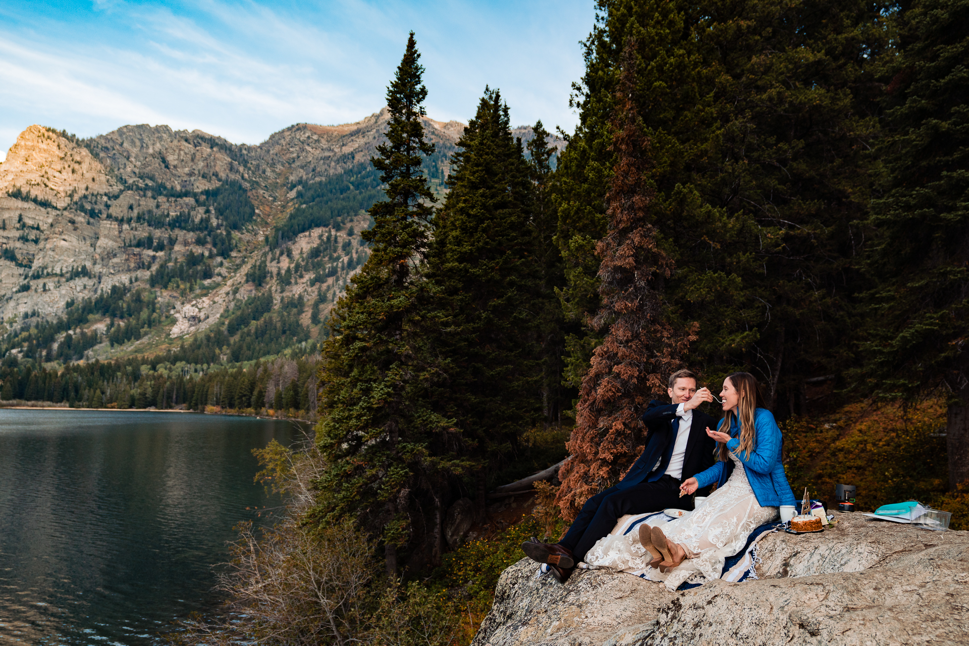 Couple sharing some of their wedding cake together after a beautiful elopement wedding ceremony in Grand Teton National Park