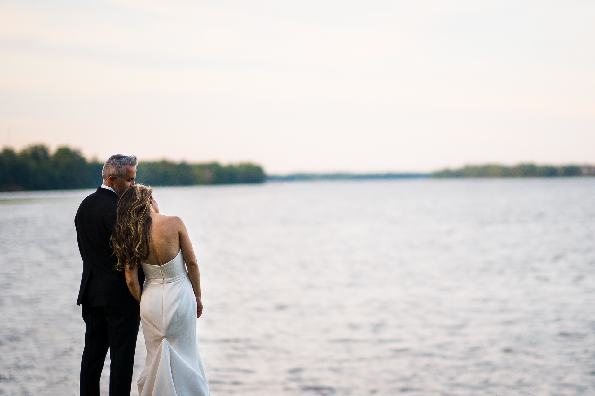 bride and groom sharing a moment on the delaware river during their wedding at Glen Foerd in Philadelphia