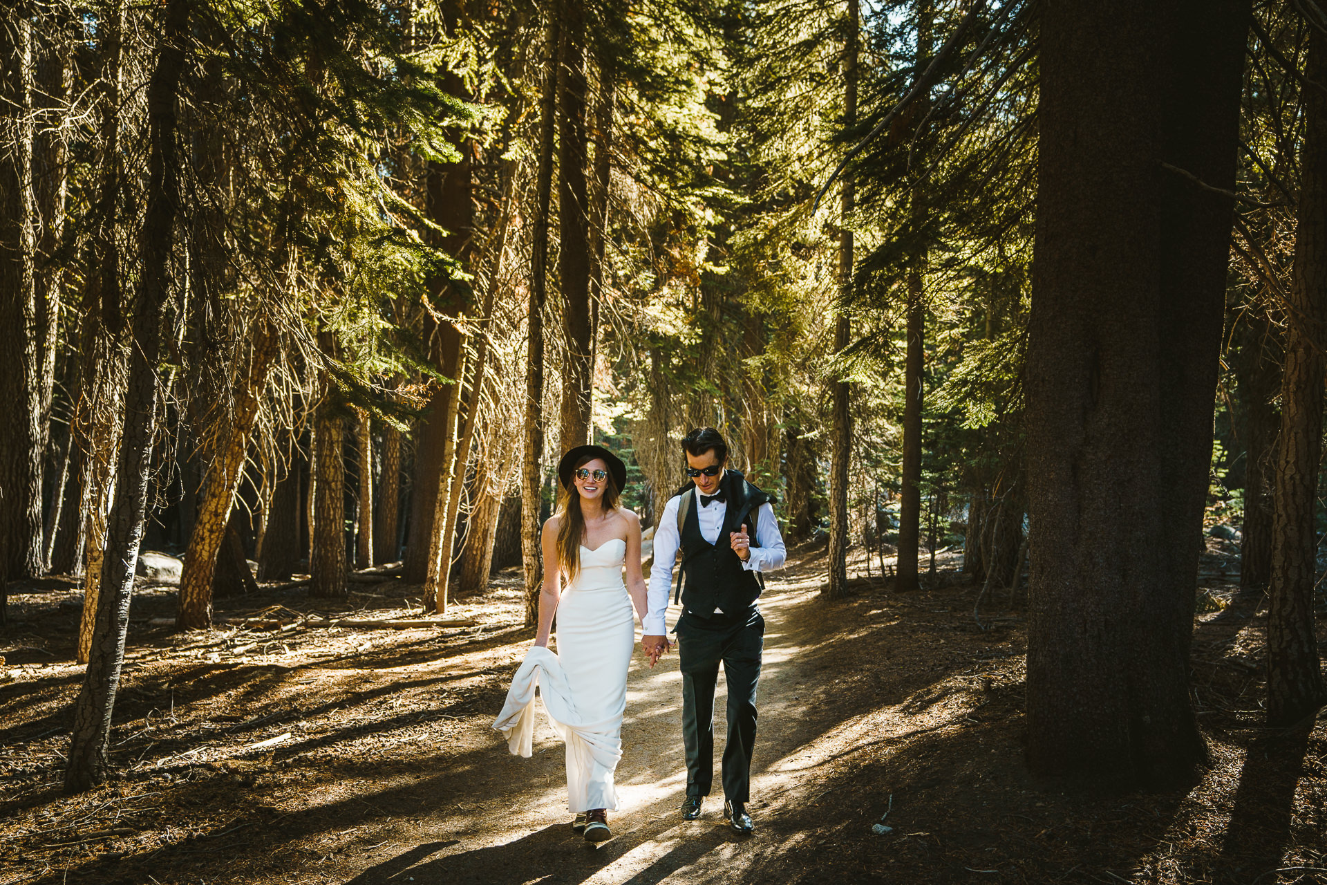 couple walking to their elopement location during an adventure session in Yosemite, California